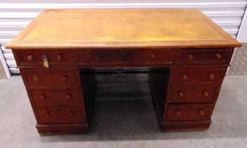 An early 20th century rectangular mahogany pedestal desk with tooled leather inset top, nine drawers