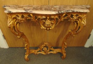 A 19th century Louis XVI style Rococo gilt wooden console table with C scroll and floral carvings