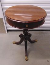 An Edwardian drum table with single drawer on three carved outswept legs with brass claw feet, 70.