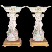 A pair of Meissen late 19th century baskets on cherub mounted pedestals, blue crossed swords marks
