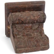 A 17th/18th century oak corbel/bracket with relief carved figure, W23cm, H20cm