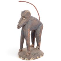 An African Tribal carved wood baboon, probably mid-20th century, H19cm