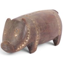 A Massim (Papua New Guinea) carved wood pig, late 19th/early 20th century, L22cm