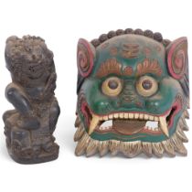 A carved and painted wood dragon war mask, H18cm, and a Burmese carved wood deity, H18cm (2)