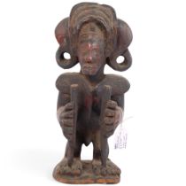 An Antique African Chokwe carved wood figure of a man, early 20th century, H27cm