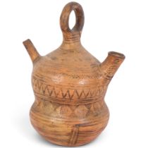 An Antique pre-Colombian style terracotta double-spouted double-gourd flask, with ring handle,