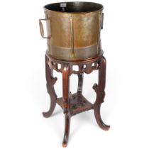 A Chinese copper drum-shaped jardiniere, on original carved hardwood stand, diameter 36cm, H81cm