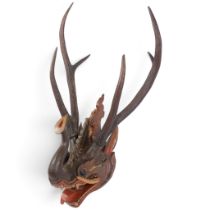 An Antique Burmese carved and painted wood Pyinsarupa head, Myanmar, with deer antler mounts
