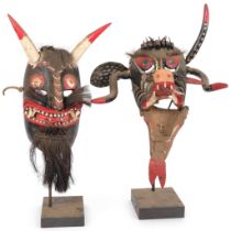 2 decorative carved and painted wood Tribal devil masks