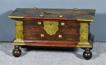 An Early 20th Century Hardwood and Brass Bound Ceylonese Chest, the panelled top with moulded