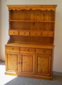 A PINE WELSH DRESSER, HAVING THREE DRAWERS ABOVE THREE CUPBOARDS
