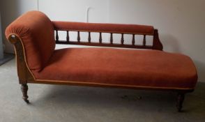VICTORIAN CARVED WALNUT CHAISE LONGUE, of typical form with foliate carved facia, spindled back