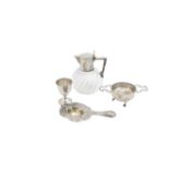 A German silver jug, two tea strainers, and an egg cup