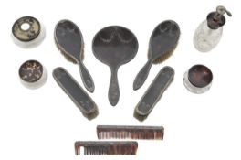 A collection of tortoiseshell and silver mounted dressing table items