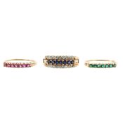 A diamond ruby sapphire and emerald stacking interchanging rings