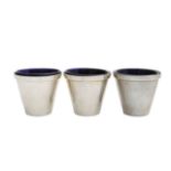 A set of three silver measuring cups