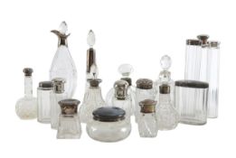 A collection of eighteen silver mounted glass bottles and a 9ct gold cheroot holder