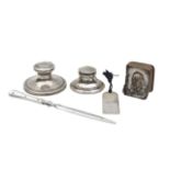 A group of silver desk items