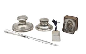 A group of silver desk items