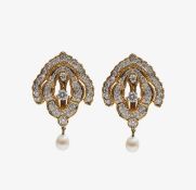 A pair of diamond encrusted statement earrings with pearl drop