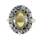 An Edwardian chrysoberyl cat's eye diamond set cluster ring