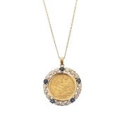 A half sovereign in a diamond and sapphire mount