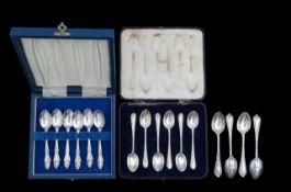 Two cased sets, and another loose set of silver spoons