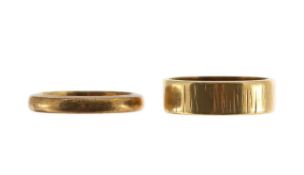 Two unmarked gold wedding bands