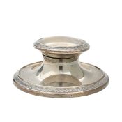 A silver capstan inkwell