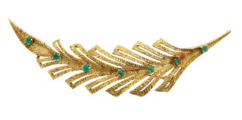 A gold stylised feather lapel brooch