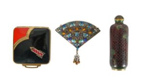 A Chinese cloisonné snuff bottle and stopper, a silver fan, and an enamel compact