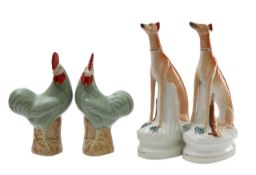 A pair of Staffordshire pottery hounds and a pair of Chinese cockerels