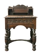 A Jacobean style carved oak writing desk
