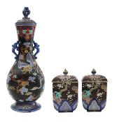 A Japanese porcelain vase, and two jars and covers