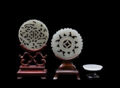 Two Chinese jade medallions, and a miniature charger