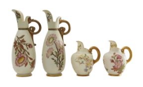 A pair of Royal Worcester blush ivory jugs and ewers
