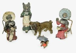 A group of four cold painted metal nodding figures