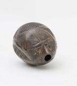 A carved coconut bugbear powder flask