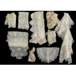 A collection of lace cuffs, neck collars, and panels