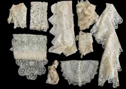 A collection of lace cuffs, neck collars, and panels