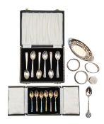 A Victorian silver basket, two cased sets of spoons, and napkin rings