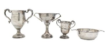A group of four silver presentation trophy cups