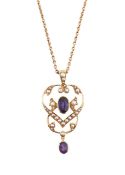 An Edwardian amethyst and seed pearl open framed pendant with chain