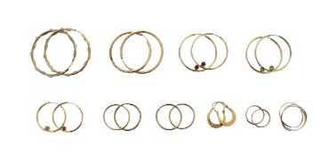 A collection of hoop earrings and a Russian wedding band