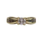 A round solitaire and baguette cut diamond ring