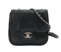 A Chanel black quilted mini flap cross-body bag