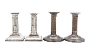 Two pairs of Edward VII silver candlesticks