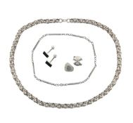 A heavy silver chain, two 1970's designer rings and others