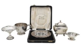 An Edward VII silver caddy, tazza, salt, mug, and ashtray