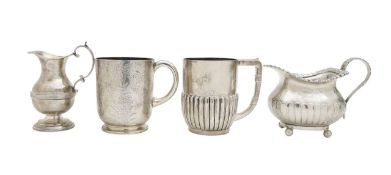 Two Victorian silver mugs, and two cream jugs